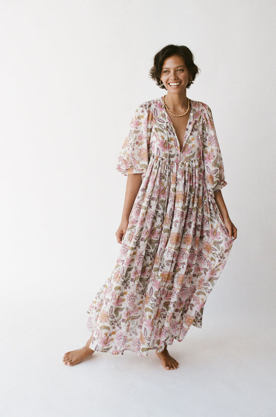 Daughters of India Kyra Maxi Dress in Fuchsia Bloom — studio full length smiling, V-neckline, flowing botanical print