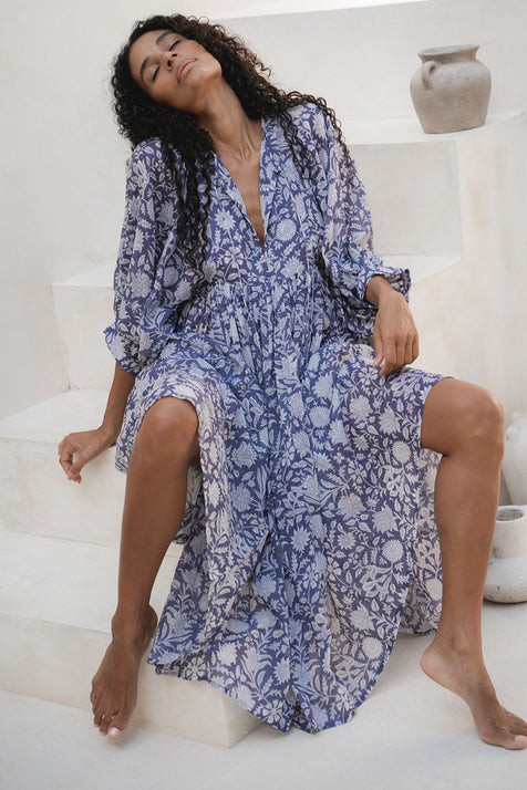 Kyra Midi Dress Blue Iris — seated on white steps, hand block print blue floral cotton midi | Daughters of India