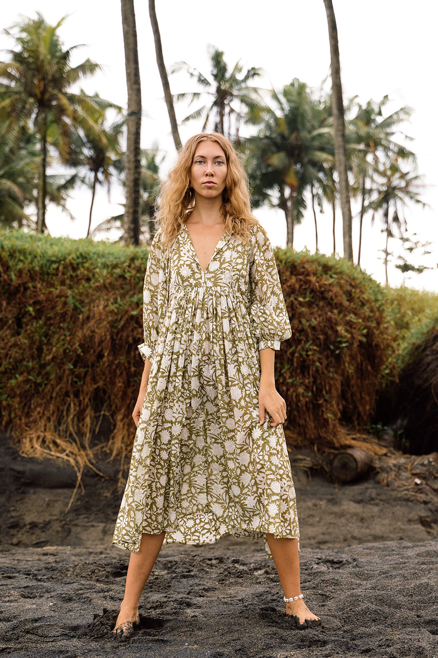 Daughters of India Kyra Midi Dress in Olive — full length on tropical beach with palm trees, hand screen print cotton
